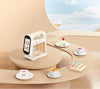 Handheld Blinkcee smart food printer machine displaying colorful food designs on a flat surface.